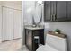 View of a bathroom featuring dark vanity, granite countertop, and linen closet at 1624 Stickney Point Rd # 24-206, Sarasota, FL 34231