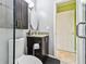 Stylish bathroom featuring dark cabinets, granite countertop and oval mirror at 1624 Stickney Point Rd # 24-206, Sarasota, FL 34231