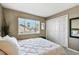 Bedroom with a large window showing tropical landscaping, and a double door closet at 1624 Stickney Point Rd # 24-206, Sarasota, FL 34231