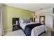 Neutral bedroom features green walls, carpet, and modern furnishings at 1624 Stickney Point Rd # 24-206, Sarasota, FL 34231