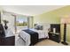 Bright bedroom featuring neutral decor, plush carpet, and large windows at 1624 Stickney Point Rd # 24-206, Sarasota, FL 34231