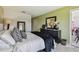 Cozy bedroom with green walls and black furniture at 1624 Stickney Point Rd # 24-206, Sarasota, FL 34231