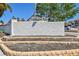 Attractive Castel Del Mare community sign with landscaping and accent lighting on a bright sunny day at 1624 Stickney Point Rd # 24-206, Sarasota, FL 34231