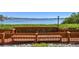 Community dock with a wood railing and view of the tranquil bay, lush greenery, and waterfront landscape at 1624 Stickney Point Rd # 24-206, Sarasota, FL 34231