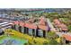 Beautiful condo community featuring tennis court, mature trees, and tropical landscaping near a waterfront at 1624 Stickney Point Rd # 24-206, Sarasota, FL 34231