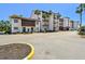 Charming condo building with Spanish-style architecture and mature palm trees at 1624 Stickney Point Rd # 24-206, Sarasota, FL 34231