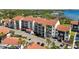 Multi-Gathering property with balconies, a red tile roof, palm trees and ample parking at 1624 Stickney Point Rd # 24-206, Sarasota, FL 34231