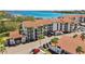 An aerial view of a multi-Gathering condo complex with balconies and mature landscaping and parking at 1624 Stickney Point Rd # 24-206, Sarasota, FL 34231