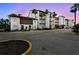 Charming condo building with Spanish-style architecture and mature palm trees at 1624 Stickney Point Rd # 24-206, Sarasota, FL 34231