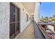 Exterior hallway to unit with stucco walls and a view of tropical landscaping at 1624 Stickney Point Rd # 24-206, Sarasota, FL 34231