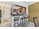 Charming kitchen features wood cabinets, stylish backsplash, and a convenient breakfast bar with seating at 1624 Stickney Point Rd # 24-206, Sarasota, FL 34231