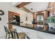 Charming kitchen features wood cabinets, stylish backsplash, and a convenient breakfast bar with seating at 1624 Stickney Point Rd # 24-206, Sarasota, FL 34231