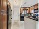 Cozy kitchen featuring black appliances, wooden cabinets, and granite countertops at 1624 Stickney Point Rd # 24-206, Sarasota, FL 34231