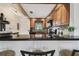 Modern kitchen featuring wood cabinets, granite counters, tile backsplash, and breakfast bar seating at 1624 Stickney Point Rd # 24-206, Sarasota, FL 34231