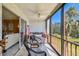 Comfortable screened lanai with fan, seating and view of the outdoors at 1624 Stickney Point Rd # 24-206, Sarasota, FL 34231