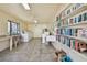 Clean laundry room featuring multiple washing machines, shelving, a sink, seating, and a window with a view at 1624 Stickney Point Rd # 24-206, Sarasota, FL 34231