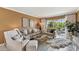 The living room features neutral walls, tile flooring, and access to outdoor patio at 1624 Stickney Point Rd # 24-206, Sarasota, FL 34231