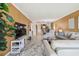 Spacious living room with modern furniture, a large TV, and open access to the kitchen at 1624 Stickney Point Rd # 24-206, Sarasota, FL 34231