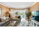 Inviting living room featuring neutral decor, plush seating, and a large sliding glass door at 1624 Stickney Point Rd # 24-206, Sarasota, FL 34231