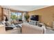 Living room featuring light-colored walls, tile floors, and a sliding glass door to the patio at 1624 Stickney Point Rd # 24-206, Sarasota, FL 34231