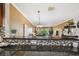 Cozy living room with open layout and bar seating, seamlessly connecting kitchen and living spaces at 1624 Stickney Point Rd # 24-206, Sarasota, FL 34231