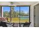 A screened patio showcases outdoor seating and beautiful views of the tennis court at 1624 Stickney Point Rd # 24-206, Sarasota, FL 34231