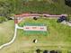 Overhead aerial view of a shuffleboard court in a sunny community with lush green grass and trees at 1624 Stickney Point Rd # 24-206, Sarasota, FL 34231