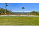 Community shuffleboard courts and benches with a view of the bay under a clear blue sky at 1624 Stickney Point Rd # 24-206, Sarasota, FL 34231