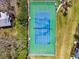 Overhead aerial view of a well-kept tennis court in a sunny community, lush green grass and trees at 1624 Stickney Point Rd # 24-206, Sarasota, FL 34231