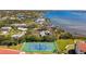 Aerial view of a well-maintained tennis court near homes in a community on a scenic waterfront at 1624 Stickney Point Rd # 24-206, Sarasota, FL 34231