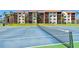 Tennis courts behind residential buildings with red tile roofs and lots of greenery at 1624 Stickney Point Rd # 24-206, Sarasota, FL 34231