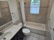 Bathroom featuring a shower-tub combination and a modern vanity with a granite countertop at 1805 9Th W St, Palmetto, FL 34221
