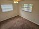 Bedroom featuring neutral walls, carpet flooring, and natural light from two large windows at 1805 9Th W St, Palmetto, FL 34221