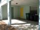 Open carport with overhead light, storage, and space for parking with durable concrete flooring at 1805 9Th W St, Palmetto, FL 34221
