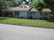 Charming single-story home with light blue exterior, brown roof, and well-maintained front yard at 1805 9Th W St, Palmetto, FL 34221