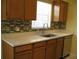 Modern kitchen with stone countertops, updated cabinets, and stylish backsplash at 1805 9Th W St, Palmetto, FL 34221