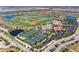 Aerial view of the tennis courts, pool, clubhouse, golf course, and beautiful landscaping in the community at 18114 Gawthrop Dr # 306, Bradenton, FL 34211