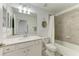 Bathroom featuring a single sink vanity, toilet, and tiled shower with tub at 18114 Gawthrop Dr # 306, Bradenton, FL 34211