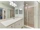 Bathroom featuring a white vanity, sink, and glass-enclosed shower with tiled walls at 18114 Gawthrop Dr # 306, Bradenton, FL 34211