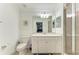 Bright bathroom with a single sink vanity, toilet, and glass shower enclosure at 18114 Gawthrop Dr # 306, Bradenton, FL 34211