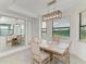 Bright dining room area with a view from the windows and a decorative mirror on the left wall at 18114 Gawthrop Dr # 306, Bradenton, FL 34211