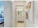 Hallway view showing bathroom featuring a white vanity and modern decor leading to main bedroom at 18114 Gawthrop Dr # 306, Bradenton, FL 34211