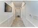 Long hallway with neutral tones, wainscoting and several closets at 18114 Gawthrop Dr # 306, Bradenton, FL 34211
