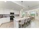 A gourmet kitchen features an island with seating, stainless steel appliances, and pendant lighting at 18114 Gawthrop Dr # 306, Bradenton, FL 34211