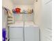 Laundry room with a white washer and dryer, shelving, and cleaning supplies at 18114 Gawthrop Dr # 306, Bradenton, FL 34211