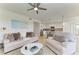 Bright living room featuring a ceiling fan and an open-concept design with a modern kitchen at 18114 Gawthrop Dr # 306, Bradenton, FL 34211