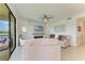 Living room with sliding doors to outdoor area, two sofas, ceiling fan, and fireplace with wall mounted television at 18114 Gawthrop Dr # 306, Bradenton, FL 34211