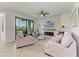 Living room with sliding doors to outdoor area, two sofas, ceiling fan, and fireplace with wall mounted television at 18114 Gawthrop Dr # 306, Bradenton, FL 34211