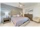 Comfortable main bedroom featuring a decorative headboard, ceiling fan, and stylish bedside tables at 18114 Gawthrop Dr # 306, Bradenton, FL 34211