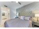 Comfortable main bedroom featuring a decorative headboard, ceiling fan, and stylish bedside tables at 18114 Gawthrop Dr # 306, Bradenton, FL 34211